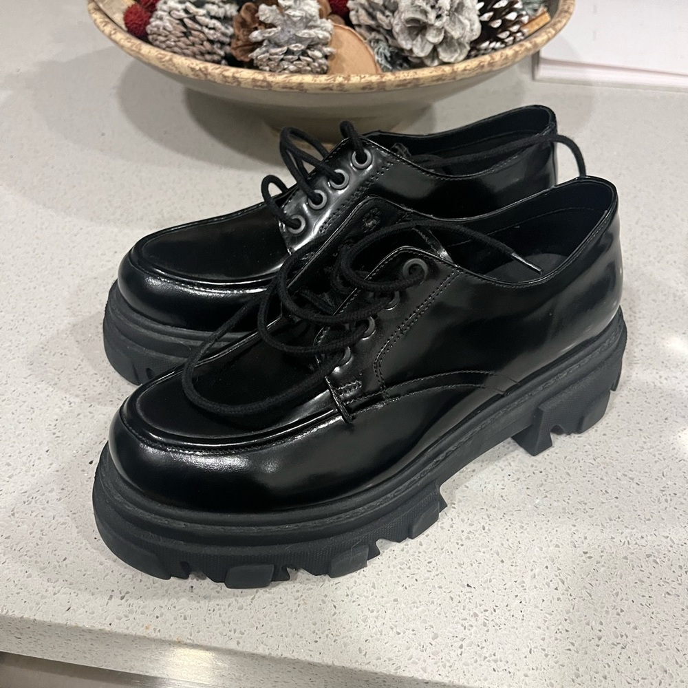 Never worn black Steve Madden lace up platforms.